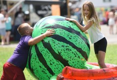 Staff file photo by Matt Hamilton / Bruce Baldwin, 8, and Amelia Nation, 9, play during the Watermelon Festival in 2025. This year's Watermelon Festival is set for 10 a.m.-5 p.m. Aug. 22, 2026, and 11 a.m.-4 p.m. Aug. 23, 2026, at McDonald Farm, 16705 Coulterville Road.