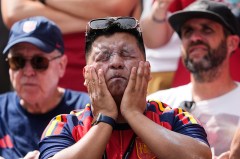 FILE - A fan puts on sunscreen prior to the World Cup Group G soccer match between Belgium and Egypt in Seattle on June 15, 2026. (AP Photo/Lindsey Wasson, File)