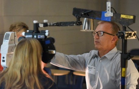 Staff photo by Matt Hamilton / Optometrist Todd Hackney helps a patient with an eye exam during the RAM Clinic at Notre Dame High School on Saturday, Oct. 17, 2026.
