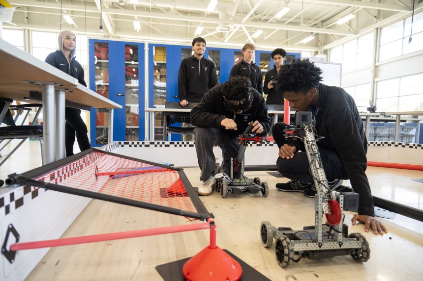 Staff Photo by Seth Carpenter/ Mechatronics Academy at Volkswagen students Camilo González, 17, center, and Raymond Guidry, 17, left, work on remote control robots at the Mechatronics Academy at Volkswagen eLab on Monday, Oct. 19, 2026.