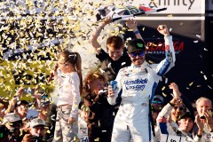 Kyle Larson celebrates with his children atop the Hendrick Motorsports No. 5 Chevrolet after winning Sunday's NASCAR Cup Series race at Alabama's Talladega Superspeedway. (AP Photo/Butch Dill)