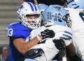 Staff photo by Matt Hamilton / Hardin Valley's Nicolas Rivers hangs onto the ball as Cleveland's Daxton Evans hits him at the line of scrimmage during the Blue Raiders' win Friday at Cleveland.