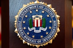 FILE - An FBI seal is displayed on a podium before a news conference at the field office in Portland, Ore., Jan. 16, 2025. (AP Photo/Jenny Kane, File)