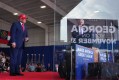President Donald Trump listens as Georgia U.S. Senate candidate Rep. Mike Collins, R-Ga., speaks at a campaign rally at Dalton Municipal Airport, Friday, Oct. 16, 2026, in Dalton Ga. (AP Photo/Mark Schiefelbein)